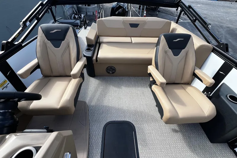 Slide: The Image of 2026 Evotti 523CS pontoon boat with beige seating, parked outdoors under a cloudy sky. - 6