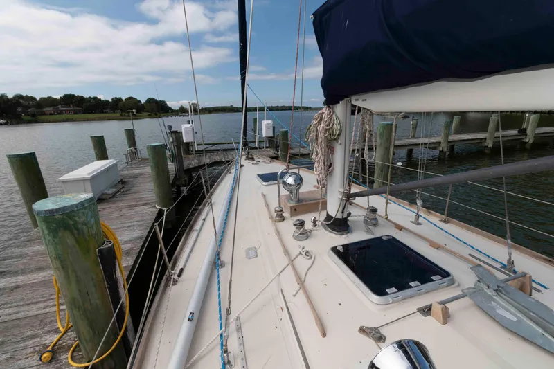Slide: The Image of 1979 Hinckley 43 Sloop docked at a marina, showcasing deck and rigging. - 3