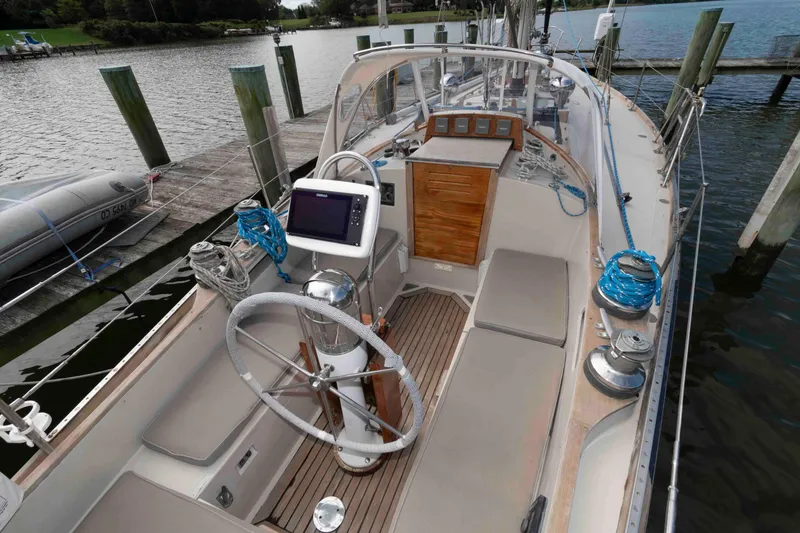 Slide: The Image of 1979 Hinckley 43 Sloop sailboat cockpit with steering wheel and navigation equipment. - 6