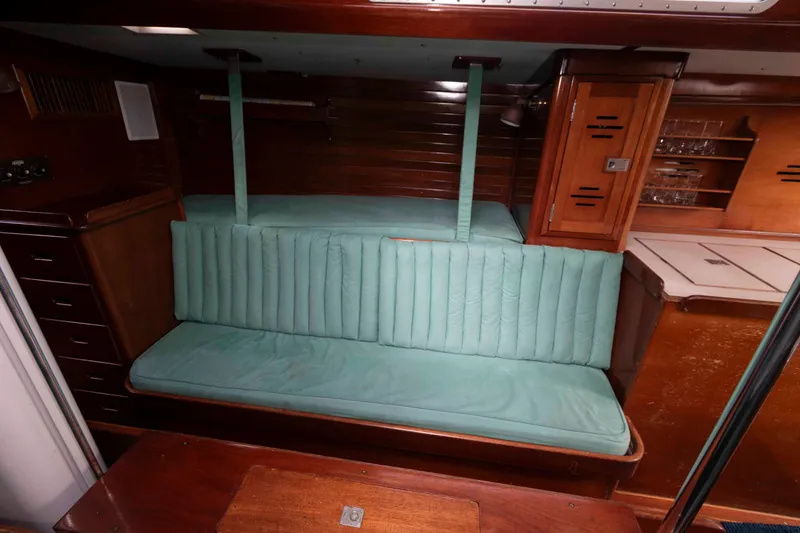 Slide: The Image of Interior of a 1979 Hinckley 43 Sloop, featuring a wooden galley and seating area. - 14
