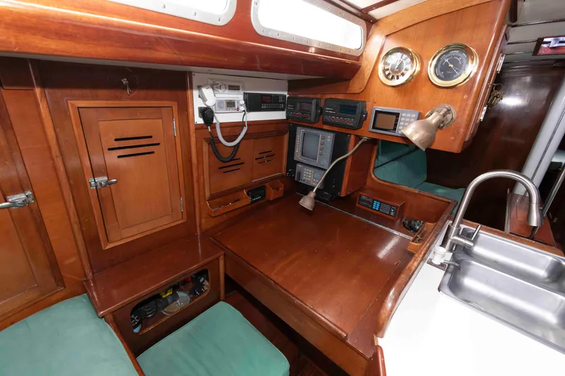 Slide: The Image of 1979 Hinckley 43 Sloop cabin interior with wooden finish and cozy bed. - 18