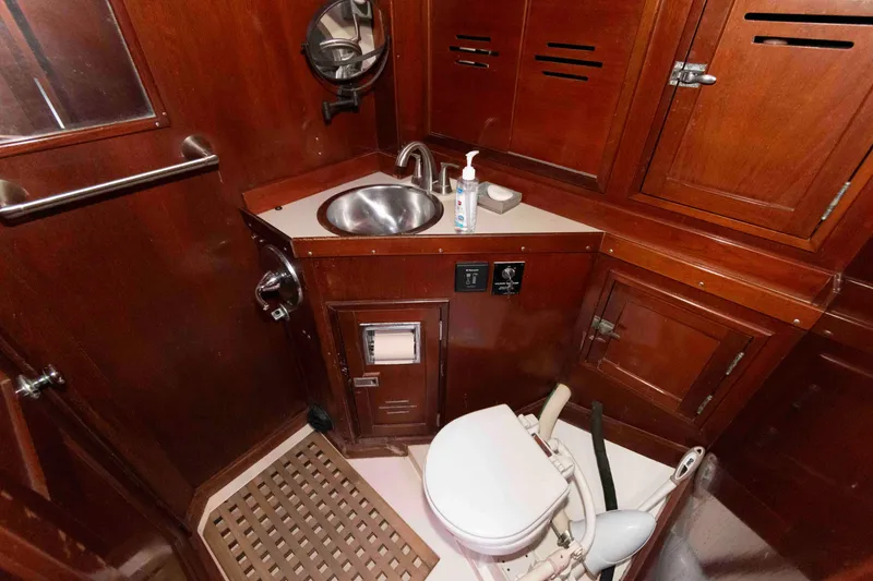 Slide: The Image of 1979 Hinckley 43 Sloop interior with wooden cabin, bed, and cup holders. - 20