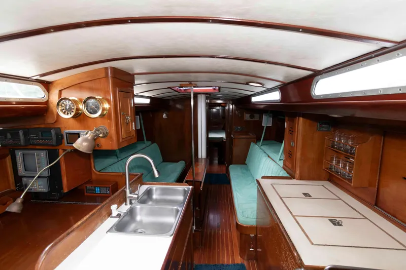 Slide: The Image of 1979 Hinckley 43 Sloop sailboat cockpit with steering wheel and navigation equipment. - 9