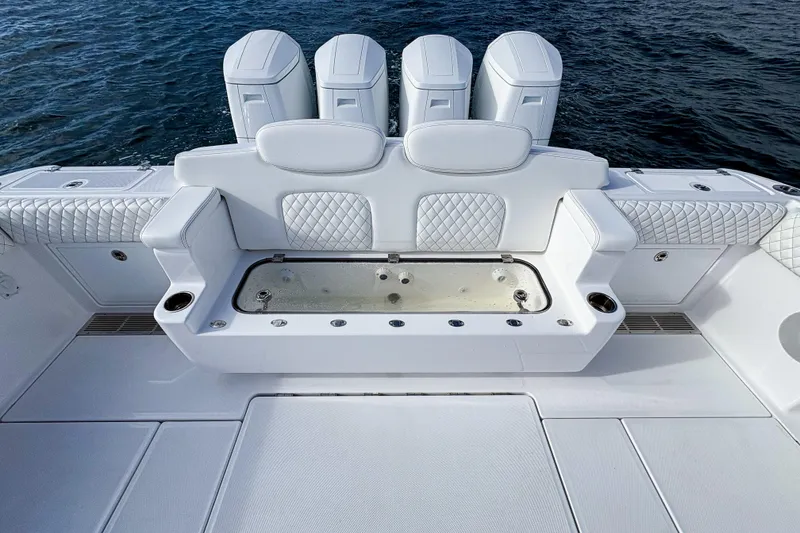 Slide: The Image of Luxury seating and storage on 2026 HCB 48 Campeon boat, featuring quilted white upholstery. - 10