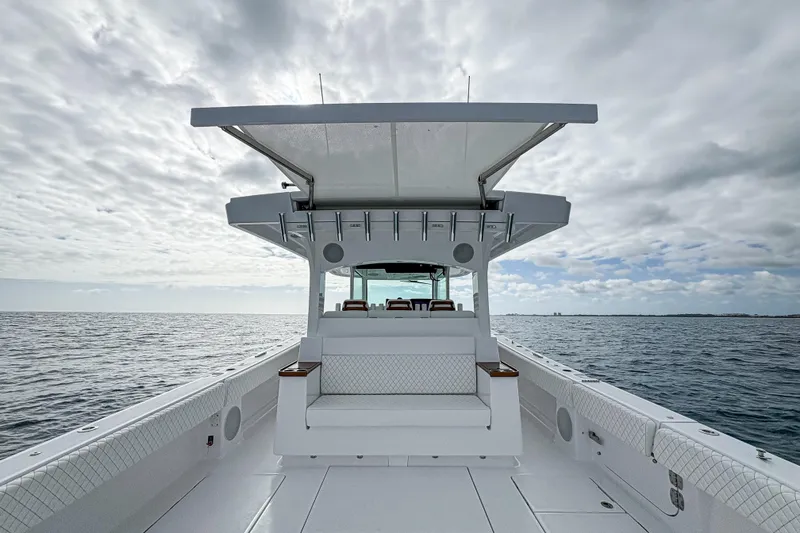 Slide: The Image of 2026 HCB 48 Campeon boat on open water under cloudy sky. - 14