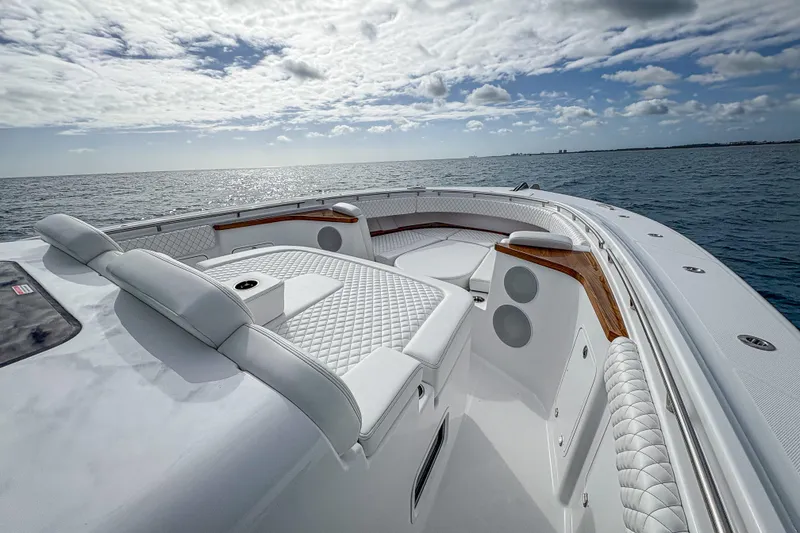 Slide: The Image of Luxurious 2026 HCB 48 Campeon yacht interior with plush seating, cruising on open sea. - 22