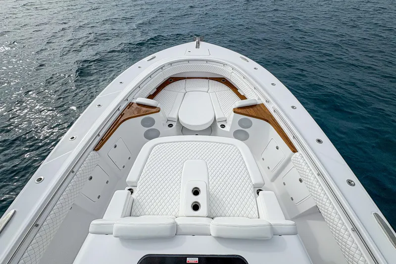 Slide: The Image of Luxurious 2026 HCB 48 Campeon boat interior with white seating and ocean backdrop. - 26