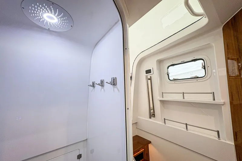 Slide: The Image of Interior of 2026 HCB 48 Campeon boat featuring modern shower and window. - 34