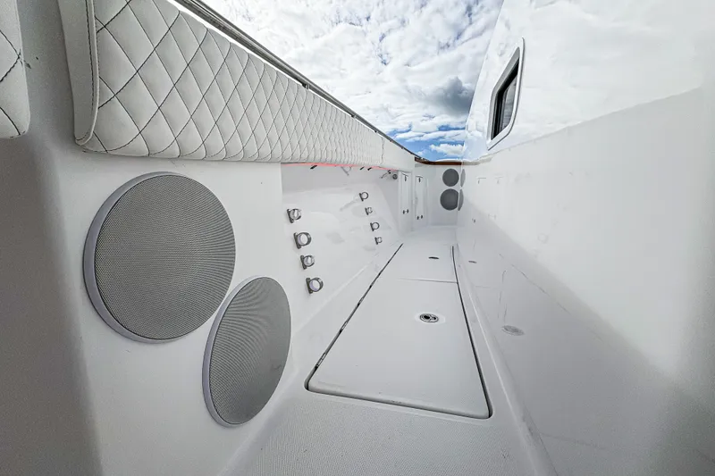 Slide: The Image of Interior view of 2026 HCB 48 Campeon boat, featuring sleek design and modern speakers. - 36