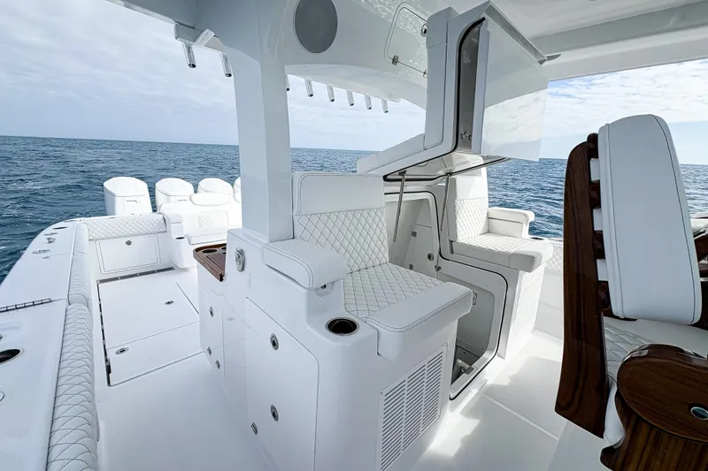 Slide: The Image of Luxurious 2026 HCB 48 Campeon boat interior with white seating and ocean view. - 4