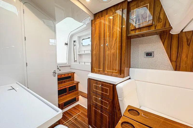 Slide: The Image of Luxurious interior of 2026 HCB 48 Campeon boat with elegant wood finishes. - 7