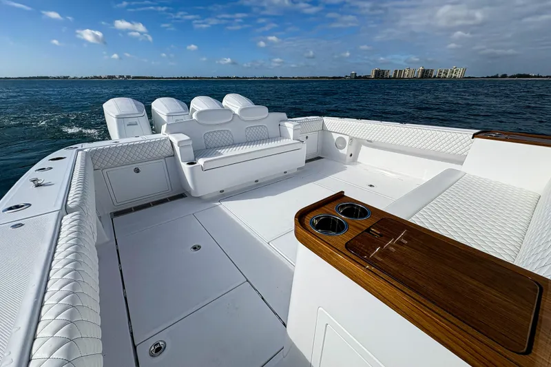 Slide: The Image of Luxurious 2026 HCB 48 Campeon boat interior with white seating and ocean view. - 9