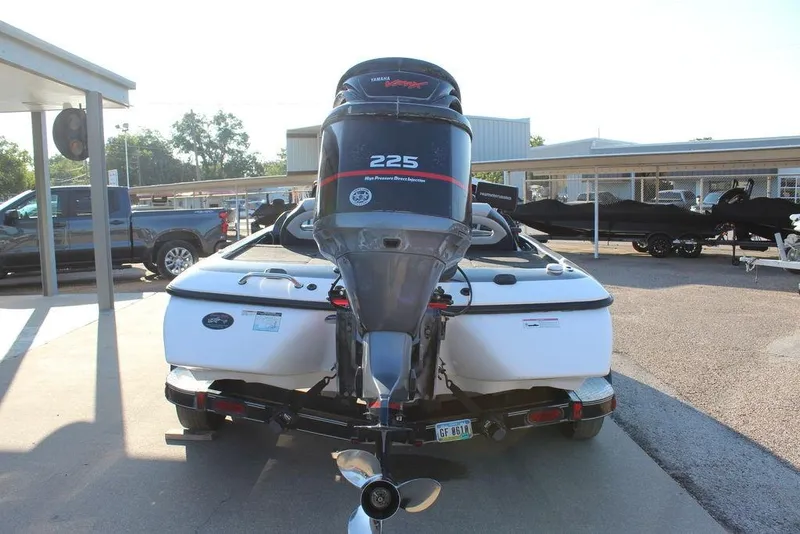 Slide: The Image of 2011 Skeeter ZX225 boat with Yamaha 225 engine, parked outdoors. - 2