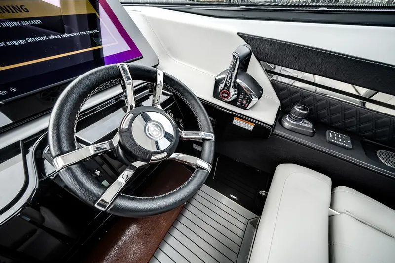 Slide: The Image of The cockpit of the 2026 Cruisers Yachts 50 GLS features a modern steering wheel and controls. - 36