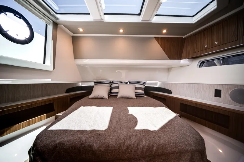 Slide: The Image of Luxurious cabin of the 2026 Cruisers Yachts 50 GLS with a large bed and skylights. - 45