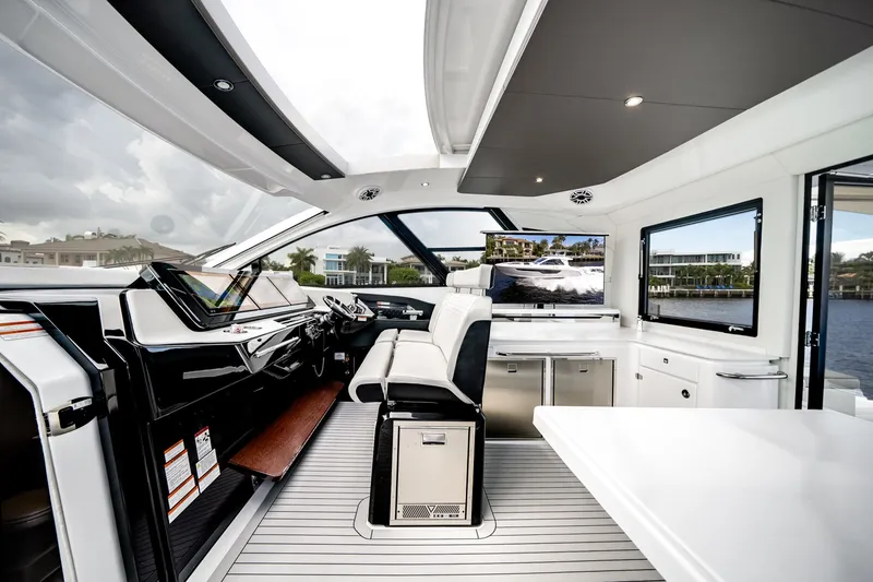 Slide: The Image of Interior of a luxury yacht with modern cockpit, white seating, and large windows. - 34