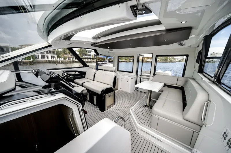 Slide: The Image of The image shows the luxurious interior of a 2026 Cruisers Yachts 50 GLS with sleek seating and a modern helm. - 37