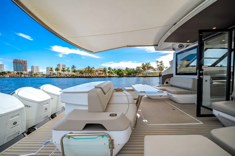 Slide: The Image of Luxurious deck of a 2026 Cruisers Yachts 50 GLS with sleek seating and a view of the skyline. - 23