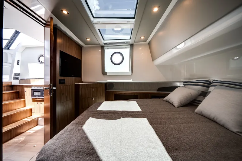 Slide: The Image of Luxurious cabin of the 2026 Cruisers Yachts 50 GLS with a double bed and skylights. - 44