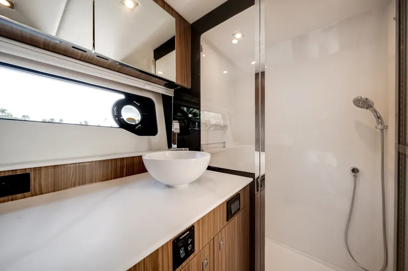 Slide: The Image of Modern bathroom with wood paneling, round sink, and shower in a yacht. - 49