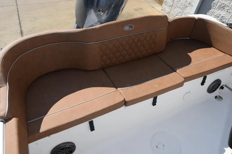 Slide: The Image of 2026 Sea Hunt Ultra 229 boat with brown cushioned seating and white deck. - 10