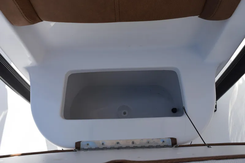 Slide: The Image of Storage compartment on 2026 Sea Hunt Ultra 229 boat, featuring white interior and brown accents. - 15