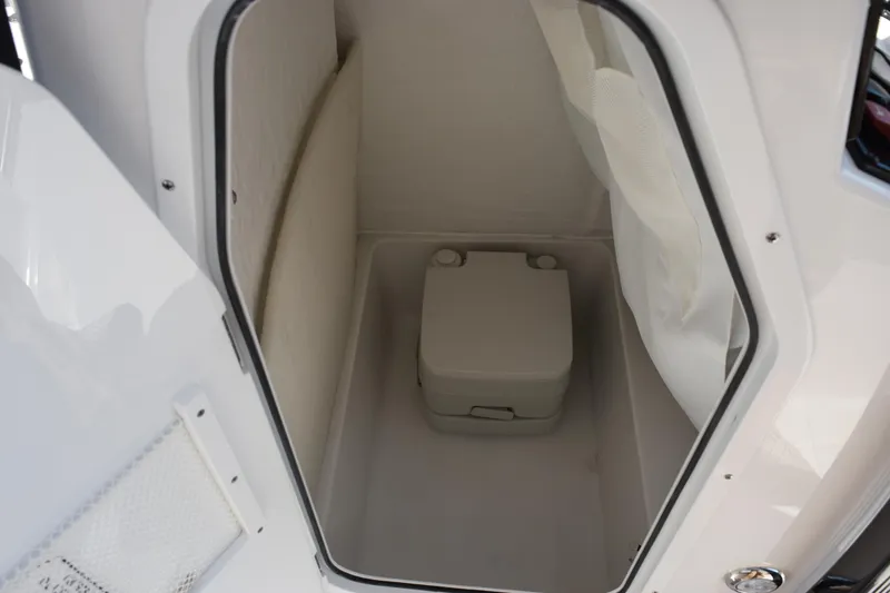 Slide: The Image of Compact marine toilet inside 2026 Sea Hunt Ultra 229 boat cabin. - 17