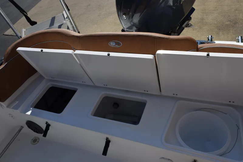 Slide: The Image of 2026 Sea Hunt Ultra 229 boat storage compartments and seating area. - 18