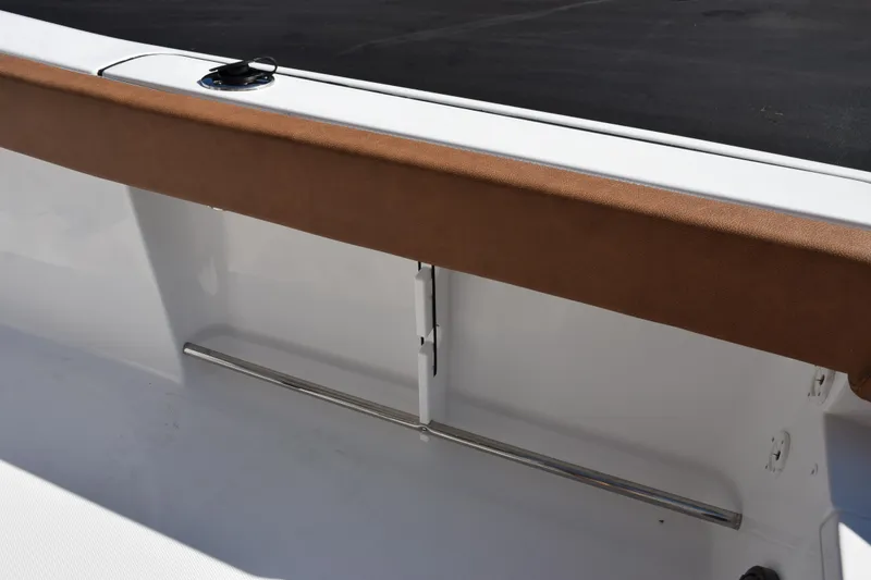Slide: The Image of 2026 Sea Hunt Ultra 229 boat interior with brown trim and stainless steel railing. - 20