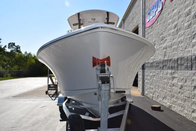 Slide: The Image of 2026 Sea Hunt Ultra 229 boat on trailer outside a building. - 3
