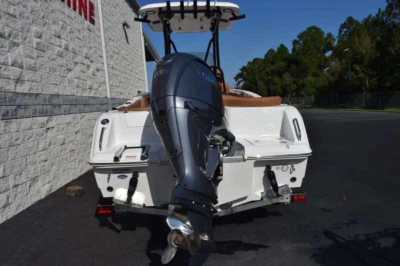 Slide: The Image of 2026 Sea Hunt Ultra 229 boat with Yamaha outboard motor, parked outdoors. - 5
