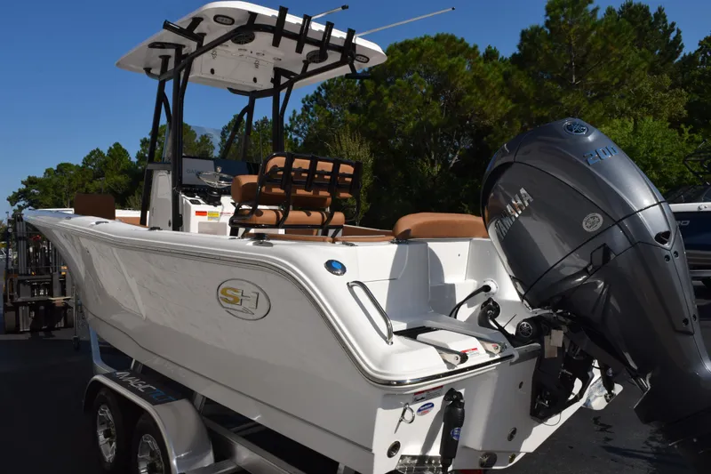 Slide: The Image of 2026 Sea Hunt Ultra 229 boat with Yamaha engine, parked on a trailer. - 6