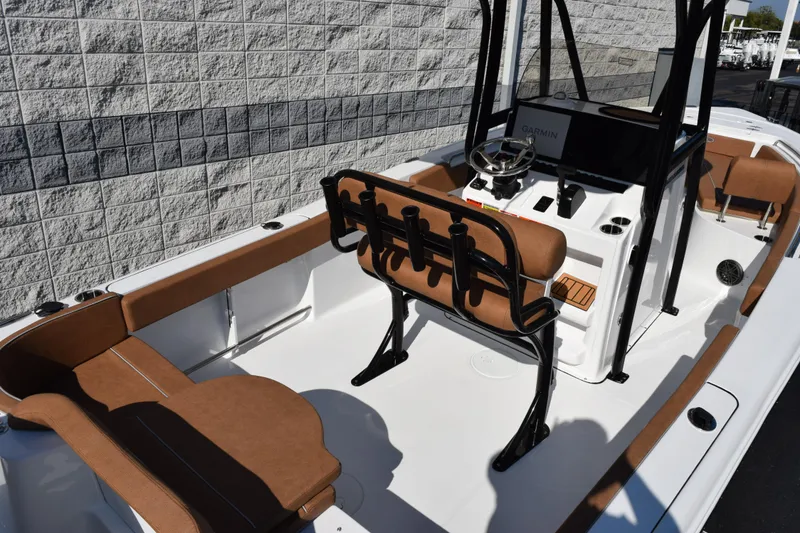 Slide: The Image of 2026 Sea Hunt Ultra 229 boat interior with brown seating and modern console. - 7