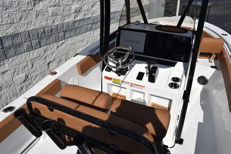 Slide: The Image of 2026 Sea Hunt Ultra 229 boat interior with Garmin navigation system and brown seating. - 8