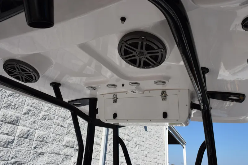 Slide: The Image of 2026 Sea Hunt Ultra 229 boat T-top with speakers and storage compartment. - 9