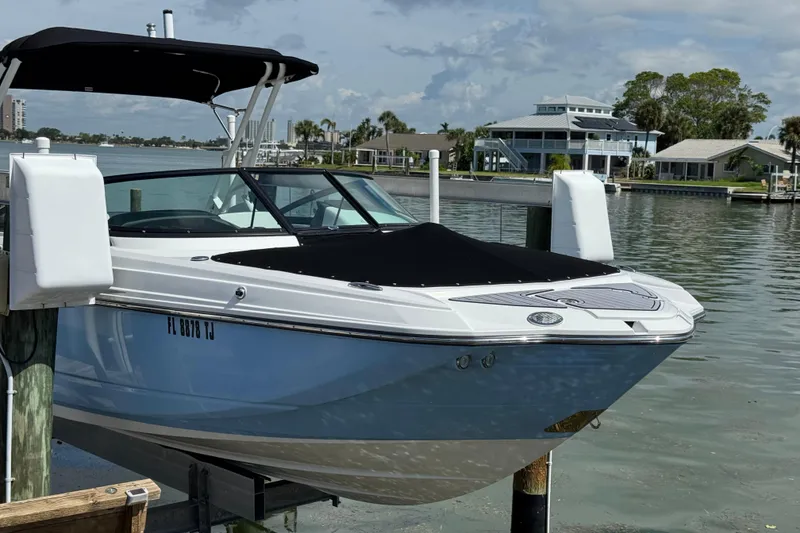 Slide: The Image of 2023 Monterey M-45 boat docked by waterfront homes under a clear sky. - 1