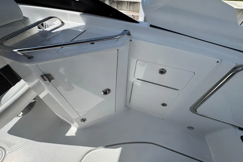 Slide: The Image of Interior of 2023 Monterey M-45 boat featuring sleek white cabinetry and stainless steel accents. - 14