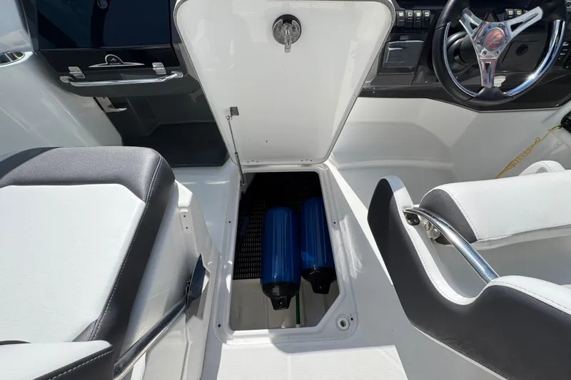 Slide: The Image of 2023 Monterey M-45 boat interior with open storage compartment and steering wheel. - 15