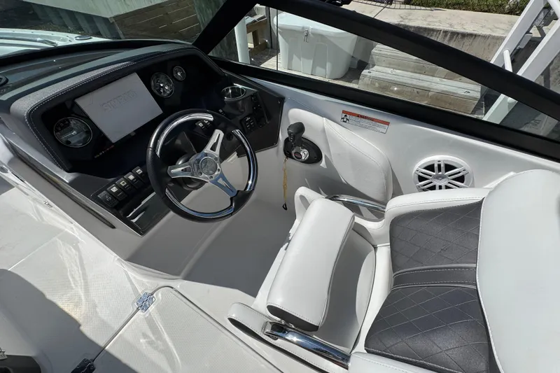 Slide: The Image of 2023 Monterey M-45 boat cockpit with steering wheel, dashboard, and luxurious seating. - 8