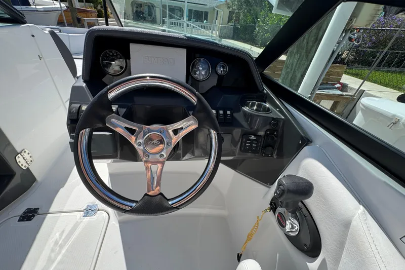 Slide: The Image of Steering wheel and dashboard of 2023 Monterey M-45 boat, featuring modern controls and gauges. - 9