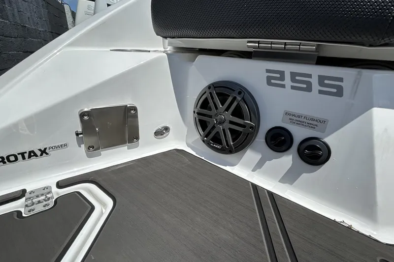 Slide: The Image of 2023 Scarab 255 ID boat interior with speaker and Rotax power branding. - 10