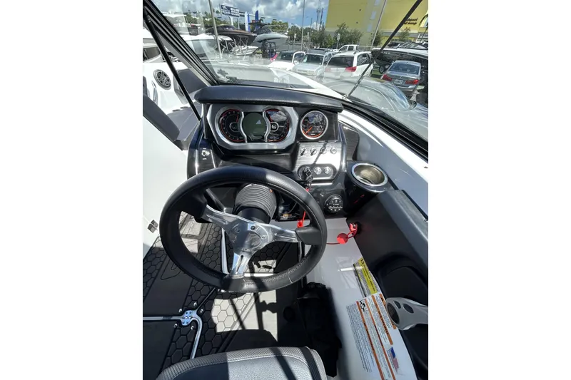 Slide: The Image of 2023 Scarab 255 ID boat dashboard with steering wheel and instrument panel. - 16