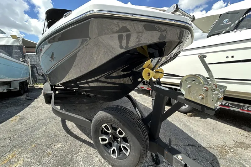 Slide: The Image of 2023 Scarab 255 ID boat on trailer, showcasing sleek hull design and modern features. - 3