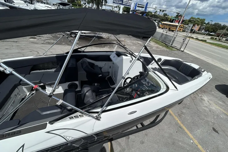 Slide: The Image of 2023 Scarab 255 ID boat with black canopy, sleek interior, and modern design. - 36