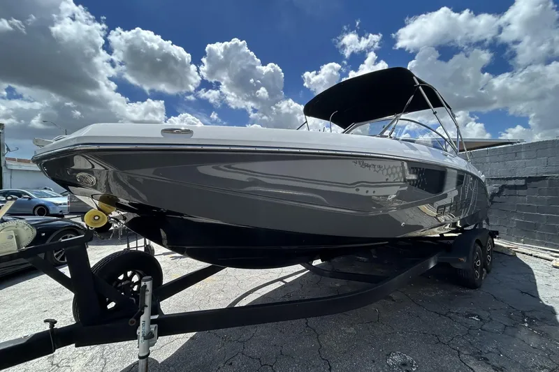 Slide: The Image of 2023 Scarab 255 ID boat on trailer under a cloudy sky. - 4