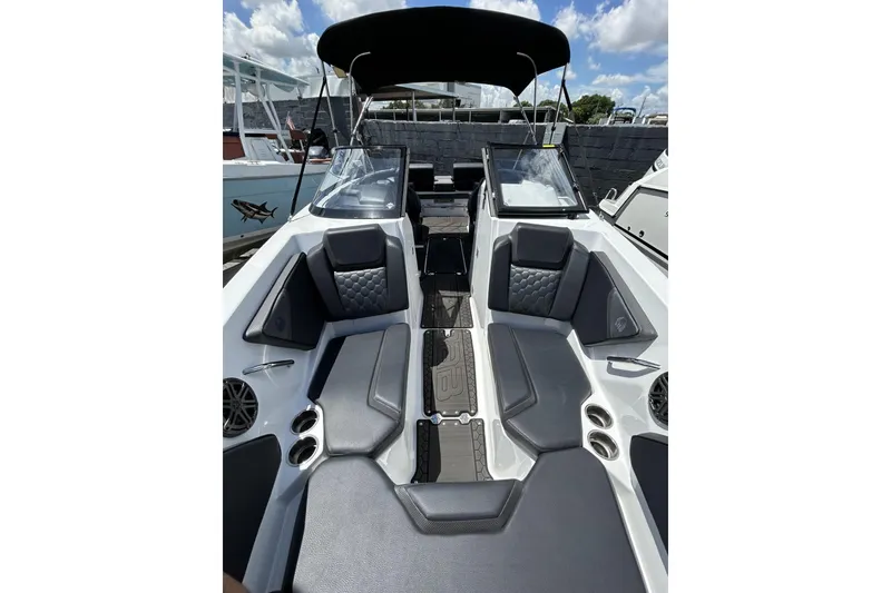 Slide: The Image of 2023 Scarab 255 ID boat interior with sleek seating and modern design under a sunny sky. - 42
