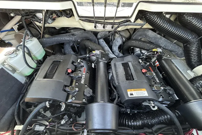 Slide: The Image of Engine compartment of 2023 Scarab 255 ID boat featuring dual Rotax engines. - 43
