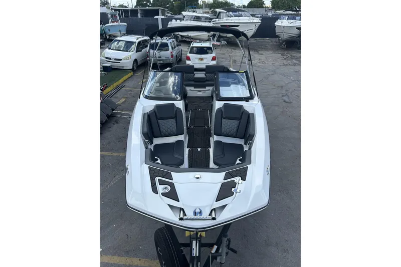 Slide: The Image of 2023 Scarab 255 ID boat with sleek design, parked in a marina with other boats. - 51