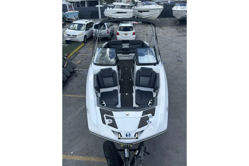 Slide: The Image of 2023 Scarab 255 ID boat with sleek design, parked in a marina. - 52