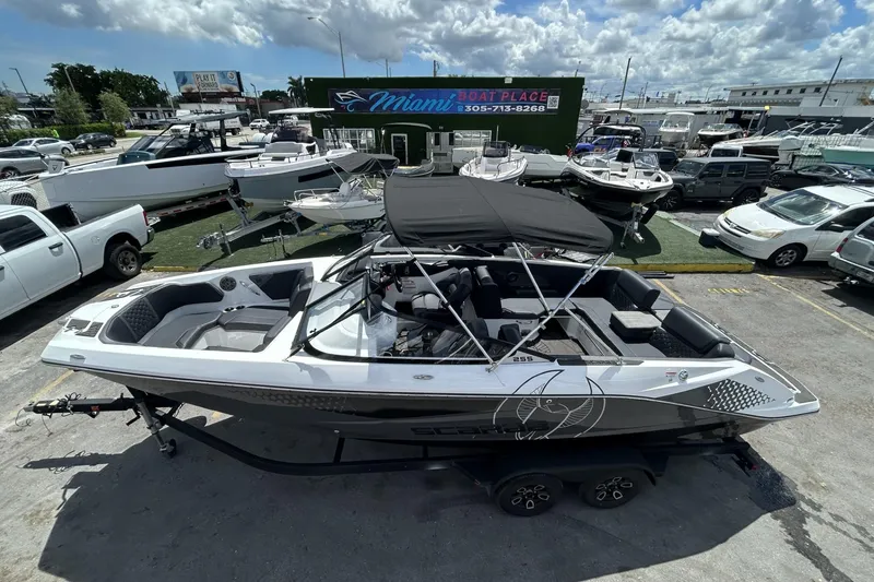 Slide: The Image of 2023 Scarab 255 ID boat with black canopy at Miami Boat Place dealership. - 54